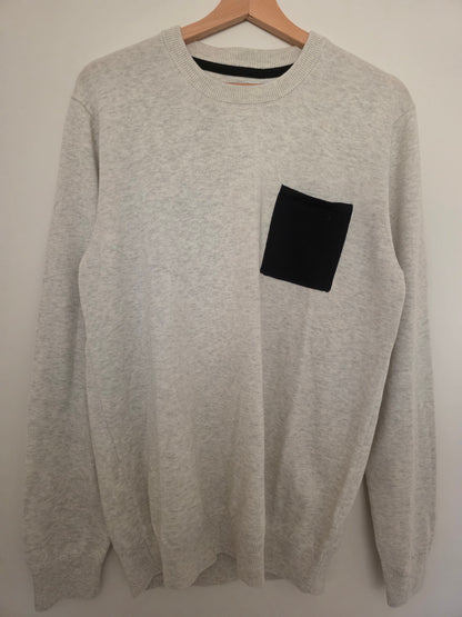 Pull col rond poche contrastée